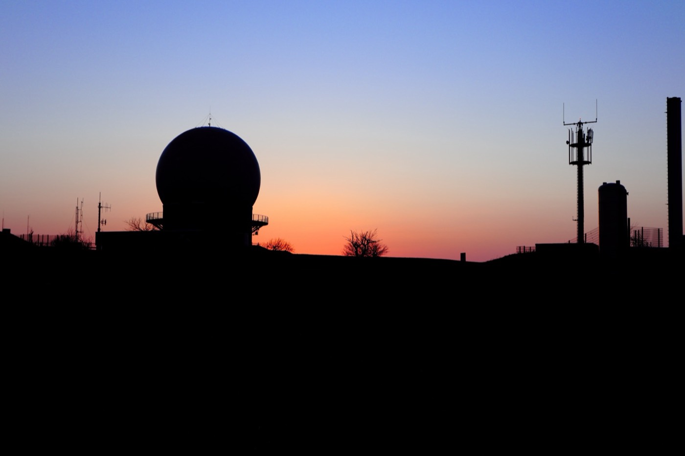 Sunset over the Wasserkuppe with silhouettes on the horizon