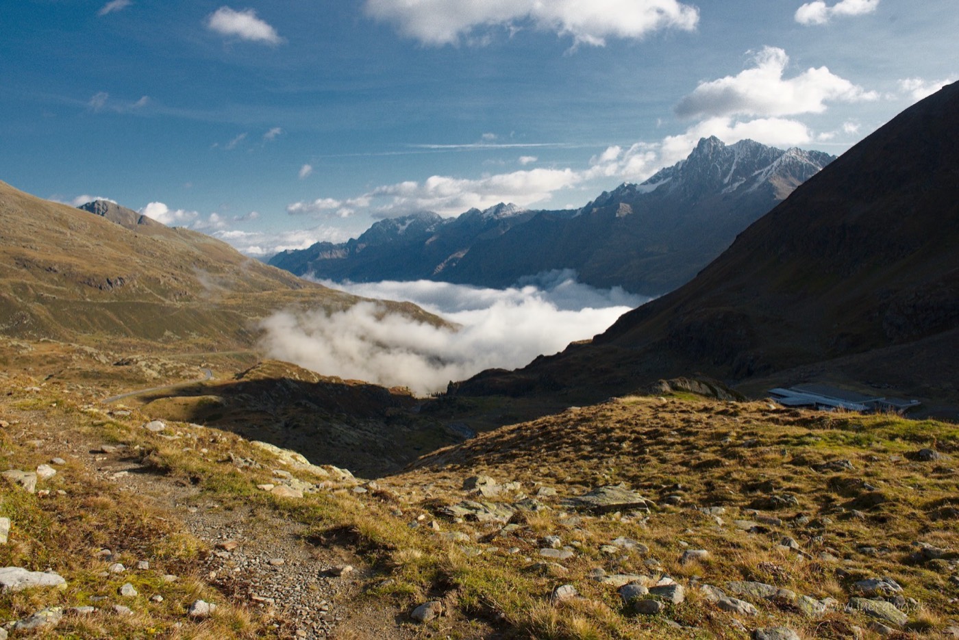 Fog in the valley, the glaciated peaks of the main alpine ridge behind